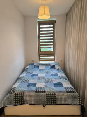 a bedroom with a bed with a checkered blanket at Modern Urban Retreat & Private Parking in Vilnius