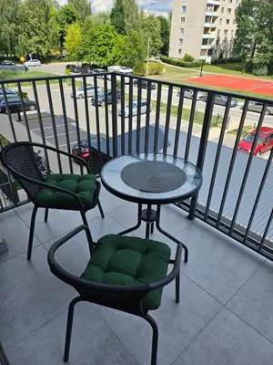 a table and two chairs on a balcony at Milda's apartment Kaunas in Kaunas