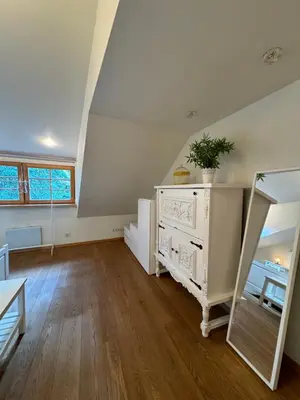 a living room with a white dresser and a mirror at Heart of Vilnius in Vilnius