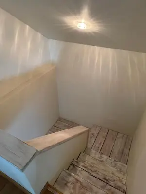 a room with a staircase in a room with a light at Heart of Vilnius in Vilnius