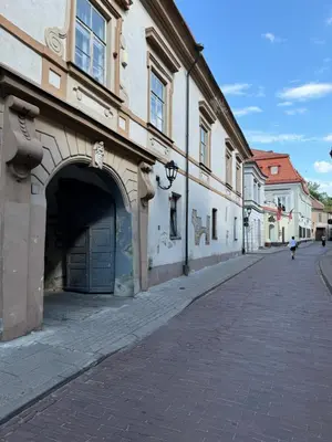 an empty street next to a building with a garage at Heart of Vilnius in Vilnius