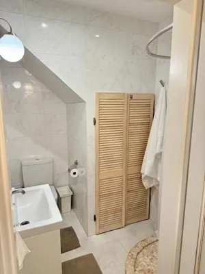 a white bathroom with a sink and a toilet at Heart of Vilnius in Vilnius
