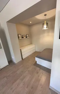 a bedroom with a bed and a shelf at Studio flat Centrinis Butukas in Kėdainiai