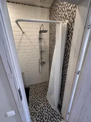 a shower with a shower curtain in a bathroom at Studio flat Centrinis Butukas in Kėdainiai