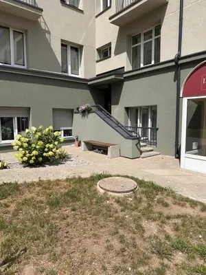 an apartment building with a staircase in front of it at Studio flat Centrinis Butukas in Kėdainiai
