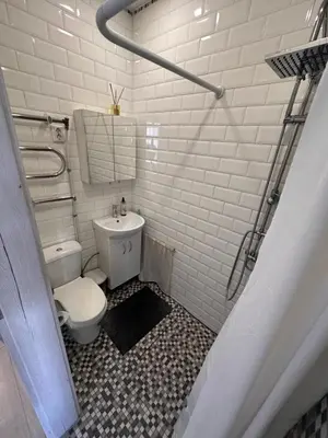 a white bathroom with a toilet and a sink at Studio flat Centrinis Butukas in Kėdainiai
