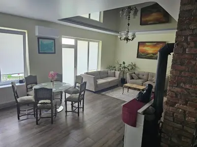 a living room with a table and chairs at Apartamentai keliaujantiems į Kauna in Garliava