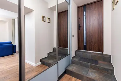 a hallway with stairs and a glass door at One-Bedroom Traku Street Apartment by Reside Baltic in Vilnius