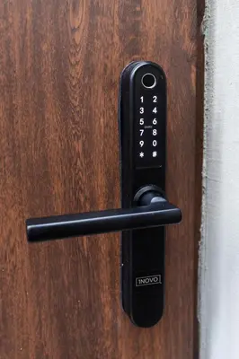 a black door handle on a wooden door at One-Bedroom Traku Street Apartment by Reside Baltic in Vilnius
