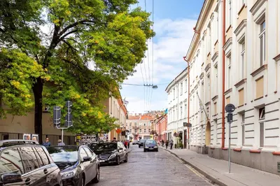 a city street with cars parked on the street at One-Bedroom Traku Street Apartment by Reside Baltic in Vilnius