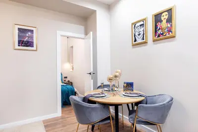 a dining room with a table and chairs at One-Bedroom Traku Street Apartment by Reside Baltic in Vilnius