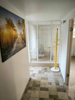 a room with a window with a table and palm trees at Elpo House in Neveronys