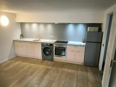a kitchen with a refrigerator and a washing machine at Elpo House in Neveronys