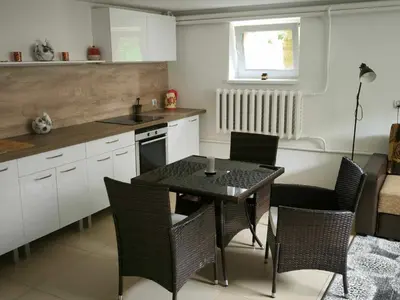 a kitchen with a table and chairs in a kitchen at Elpo House in Neveronys