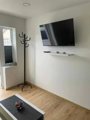 a living room with a flat screen tv on the wall at Jolantos svečių namai in Rokiškis