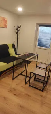 a living room with a glass table and a couch at Jolantos svečių namai in Rokiškis