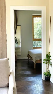a living room with a bed and a window at Floral Sunshine Apartment in Vilnius