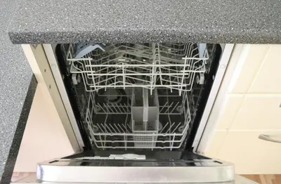 an open dishwasher in a kitchen at Green House Apartment in Kaunas