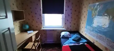 a room with a bed and a desk and a window at EirForce1 in Kaunas