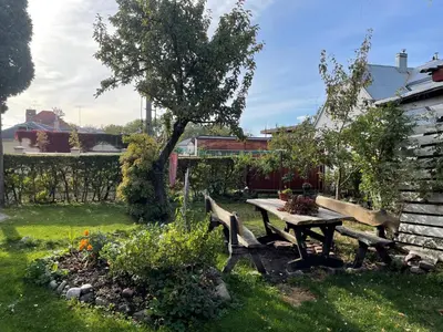 a picnic table and benches in a garden at EirForce1 in Kaunas