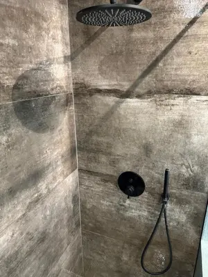 a shower with a shower head in a bathroom at Cotta in Karkazai