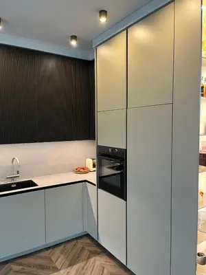 a kitchen with white cabinets and a black refrigerator at Cotta in Karkazai