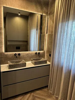 a bathroom with two sinks and a large mirror at Cotta in Karkazai