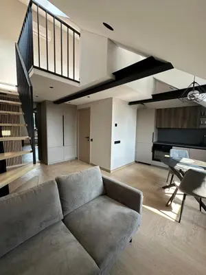 a living room with a couch and a table at Studio 11 - old town Kaunas in Kaunas