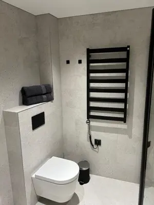 a bathroom with a toilet and a towel rack at Studio 11 - old town Kaunas in Kaunas