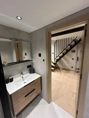 a bathroom with a sink and a staircase at Studio 11 - old town Kaunas in Kaunas