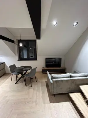 a living room with a couch and a table at Studio 11 - old town Kaunas in Kaunas