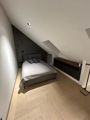 a bedroom with a bed in a attic at Studio 11 - old town Kaunas in Kaunas