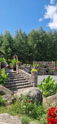 a set of stairs in a garden with flowers at Namas su pirtimi Trakai in Salkininkai