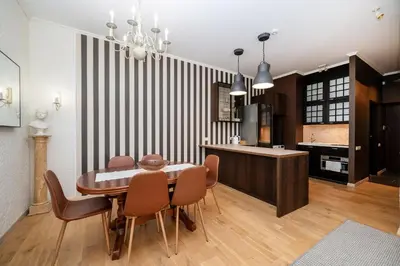 a kitchen and dining room with a table and chairs at Spacious Apartment In Vilnius Old Town by Reside Baltic in Vilnius