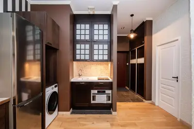 a kitchen with a sink and a washer and dryer at Spacious Apartment In Vilnius Old Town by Reside Baltic in Vilnius