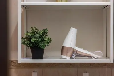 a shelf with a potted plant and a pair of shoes at Spacious Apartment In Vilnius Old Town by Reside Baltic in Vilnius