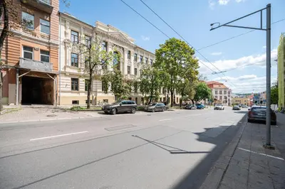 an empty city street with cars parked on the road at Spacious Apartment In Vilnius Old Town by Reside Baltic in Vilnius