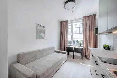 a living room with a couch and a table at P-ONE APARTMENTS - Self Check-in in Vilnius