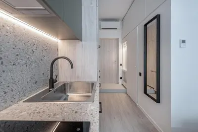 a kitchen with a sink and a counter at P-ONE APARTMENTS - Self Check-in in Vilnius