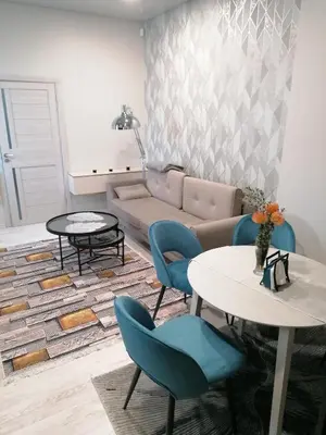 a living room with a couch and a table and chairs at Čiurlionio 14 in Kaunas