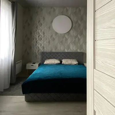a bedroom with a blue bed and a wall at Čiurlionio 14 in Kaunas