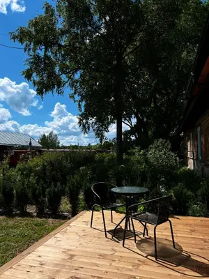 a table and two chairs sitting on a patio at Vilties vila in Anykščiai