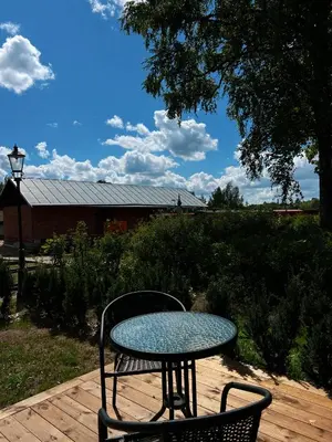 a table and chairs sitting on a wooden deck at Vilties vila in Anykščiai
