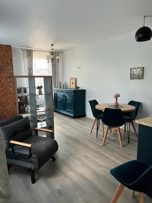 a living room with a table and chairs at Vilties vila in Anykščiai
