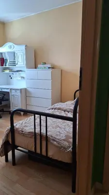 a small bedroom with a bed and a desk at Butas1 in Vilnius
