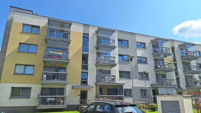an apartment building with a car parked in front of it at Butas1 in Vilnius