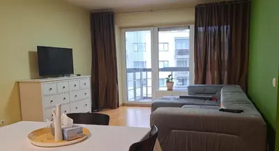 a living room with a couch and a tv at Butas1 in Vilnius