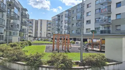 a playground in front of a apartment building at Butas1 in Vilnius