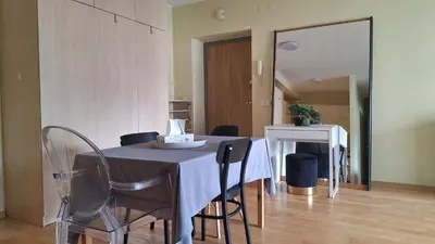 a dining room with a table and chairs at Butas1 in Vilnius