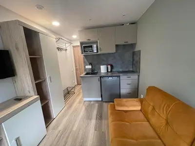 a small kitchen with a couch in a small apartment at 24h self check-in COZY VISIT Studio3 on the first floor in Kaunas